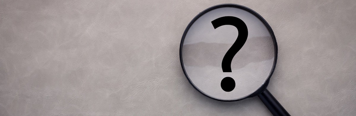 magnifying glass and a question mark on the leather background
