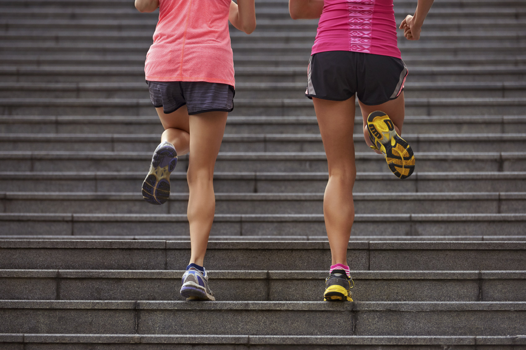 active sporty women working out running up stairs outdoors for morning workout