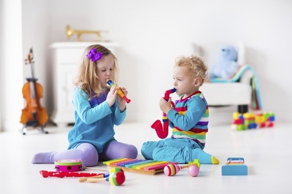 Children with music instruments. Musical education for kids. Colorful wooden art toys. Little girl and boy play music. Kid with xylophone, guitar, flute, violin. Early development for toddler and baby